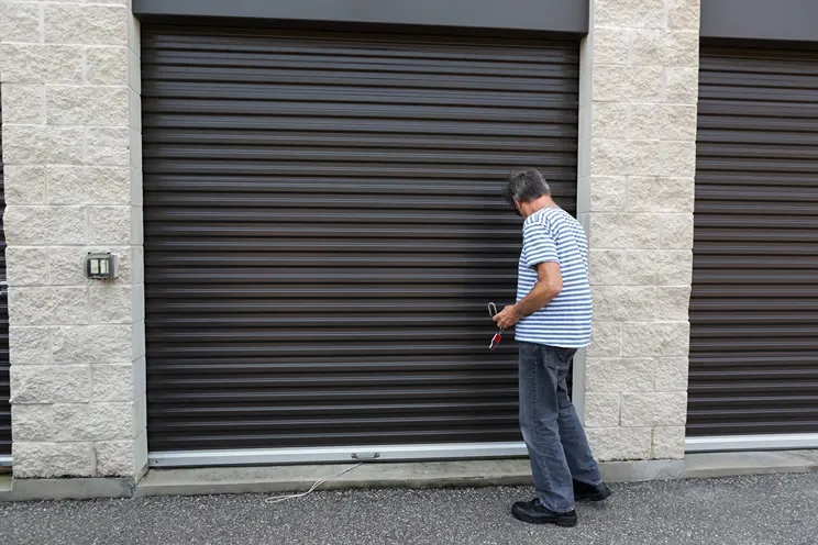 Man opening a drive up storage unit